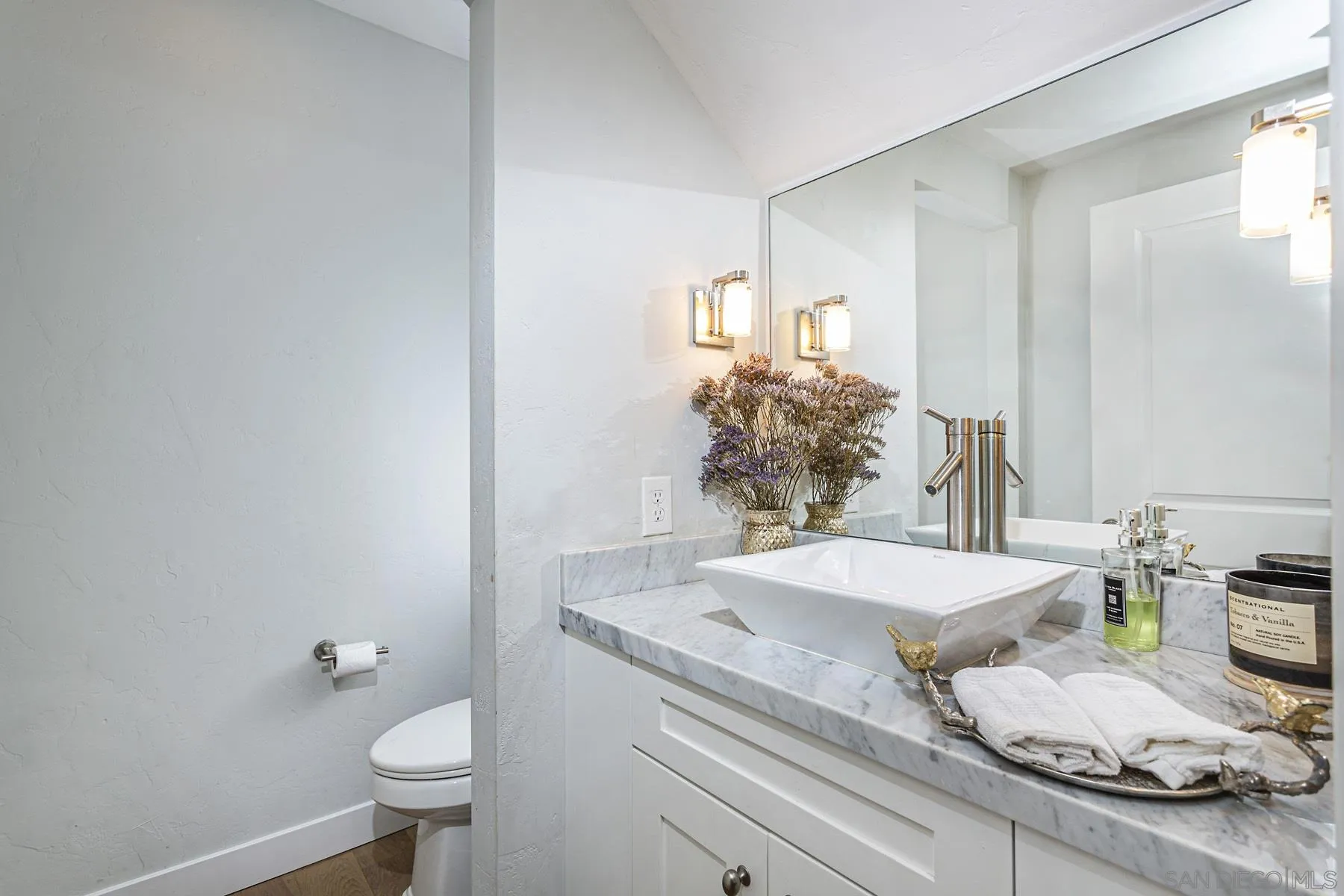 340 A Avenue Coronado, CA 92118 - Photo 10 of 41 a bathroom with a granite countertop sink a toilet and a mirror