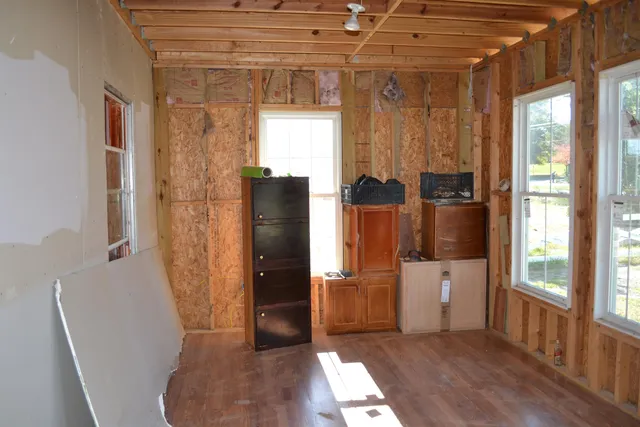 a view of kitchen with furniture and refrigerator