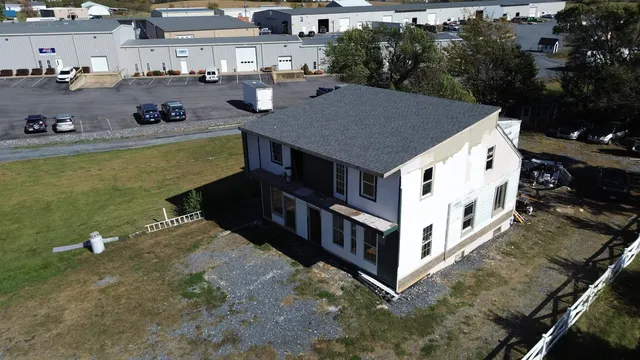 a view of a house with backyard and sitting area
