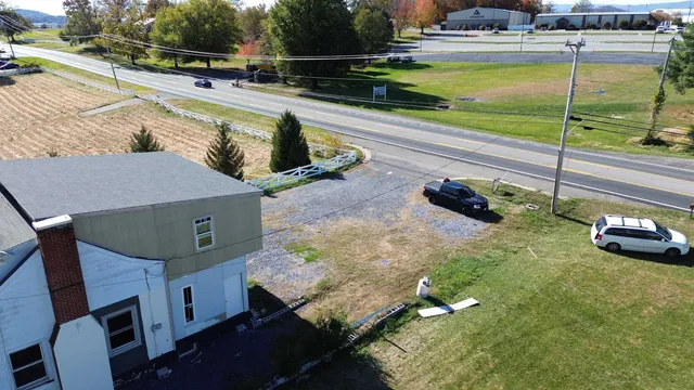 a view of a swimming pool with a patio and a yard