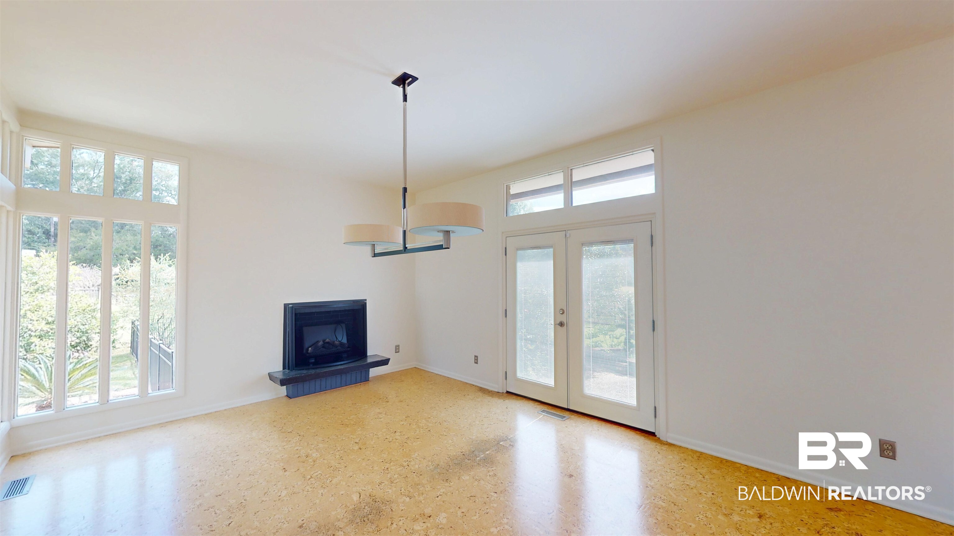 15 Spring Bank Road Mobile, AL 36608 - Photo 12 of 58 Unfurnished living room featuring french doors and baseboards