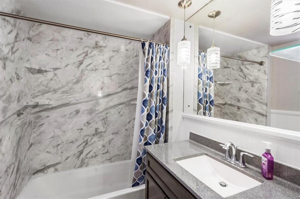 528 Loretto Road Pittsburgh, PA 15217 - Photo 23 of 39 The master bathroom has had a makeover with new vanity, vinyl plank flooring and updated shower insert. Pendant lights keep it bright.