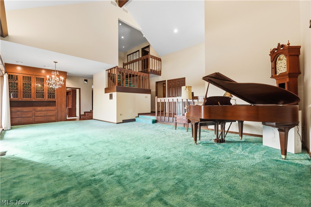 7014 River Styx Road Medina, OH 44256 - Photo 5 of 50 Living area featuring a towering ceiling, carpet floors, recessed lighting, and a chandelier
