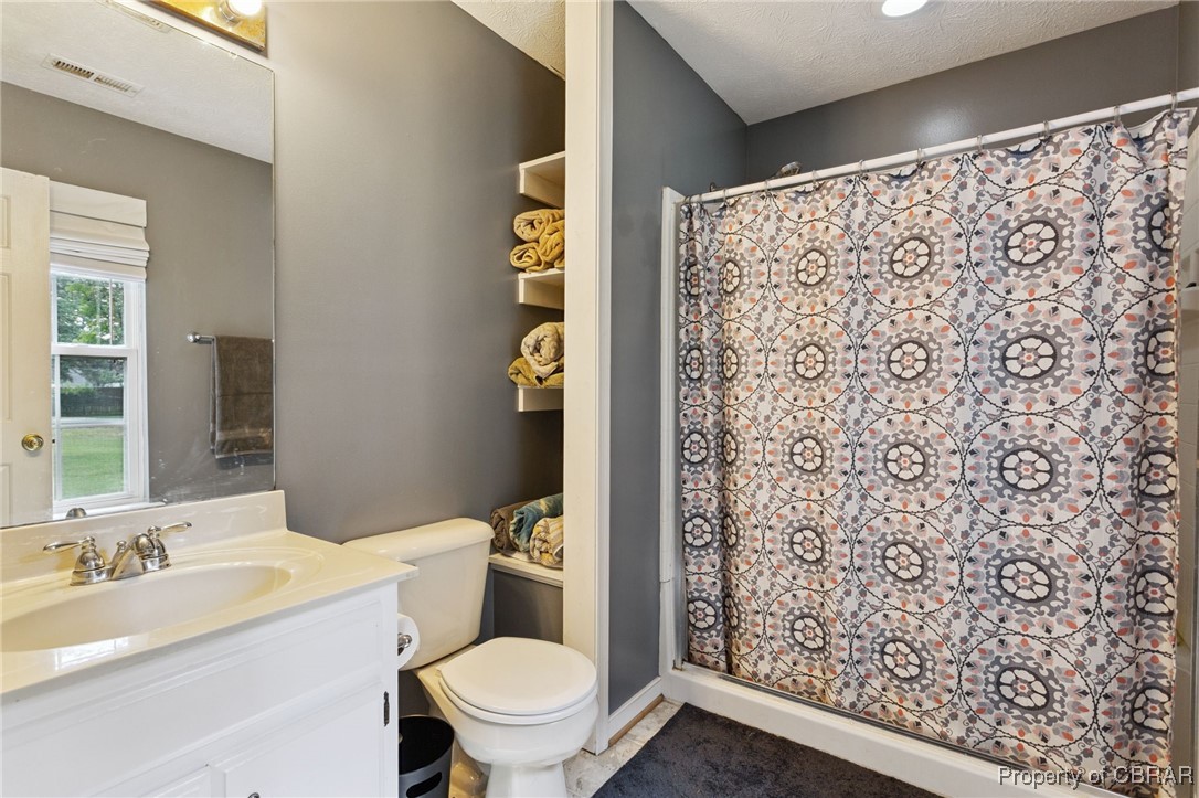7989 Pinetta Road Gloucester, VA 23061 - Photo 11 of 26 Bathroom featuring vanity and a shower with curtain