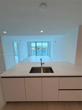 a kitchen with a sink a stove and chairs