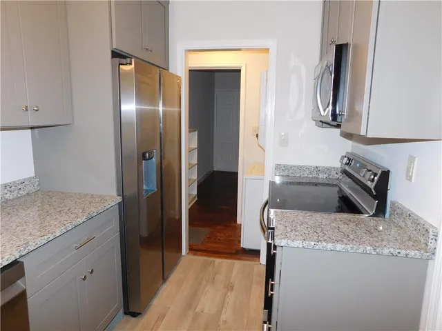 a kitchen with a refrigerator and a sink