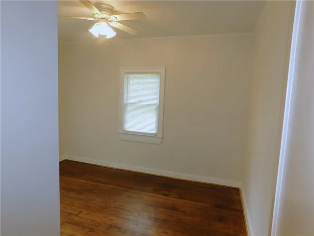a view of a room with wooden floor and fan
