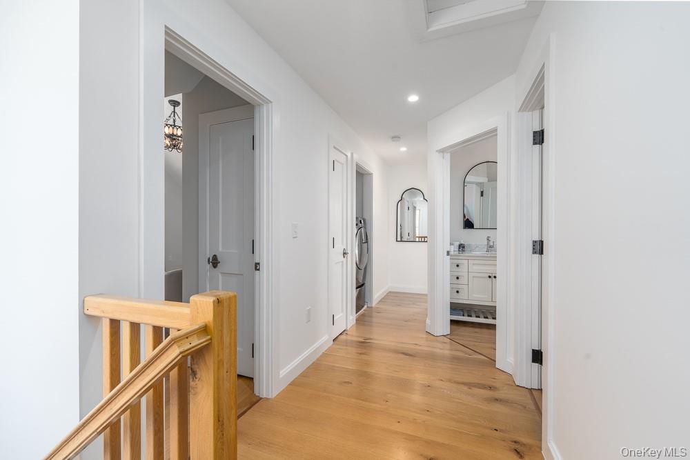 19000 Main Road Mattituck, NY 11952 - Photo 17 of 32 Hallway with light wood-type flooring, recessed lighting, a sink, and baseboards