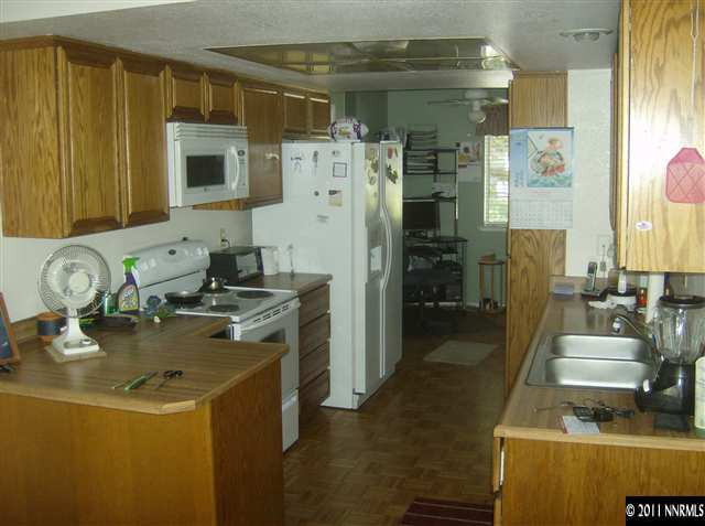 6020 Conness Way Reno, NV 89523 - Photo 2 of 9 a kitchen with a refrigerator and a stove