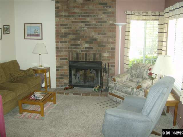 6020 Conness Way Reno, NV 89523 - Photo 3 of 9 a living room with furniture and a fireplace