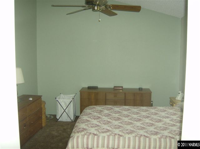6020 Conness Way Reno, NV 89523 - Photo 7 of 9 a bedroom with a bed and a dresser