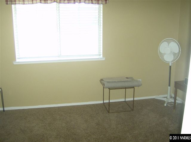 6020 Conness Way Reno, NV 89523 - Photo 8 of 9 a view of a room with a window and a potted plant on a table