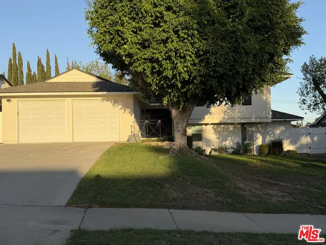 a front view of a house with yard