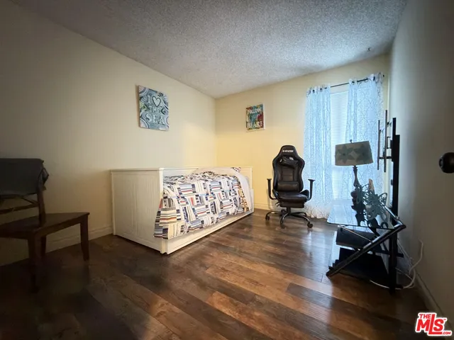 a bedroom with furniture and wooden floor