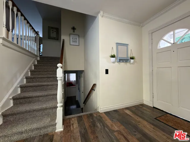 a view of entryway with stairs and wooden floor