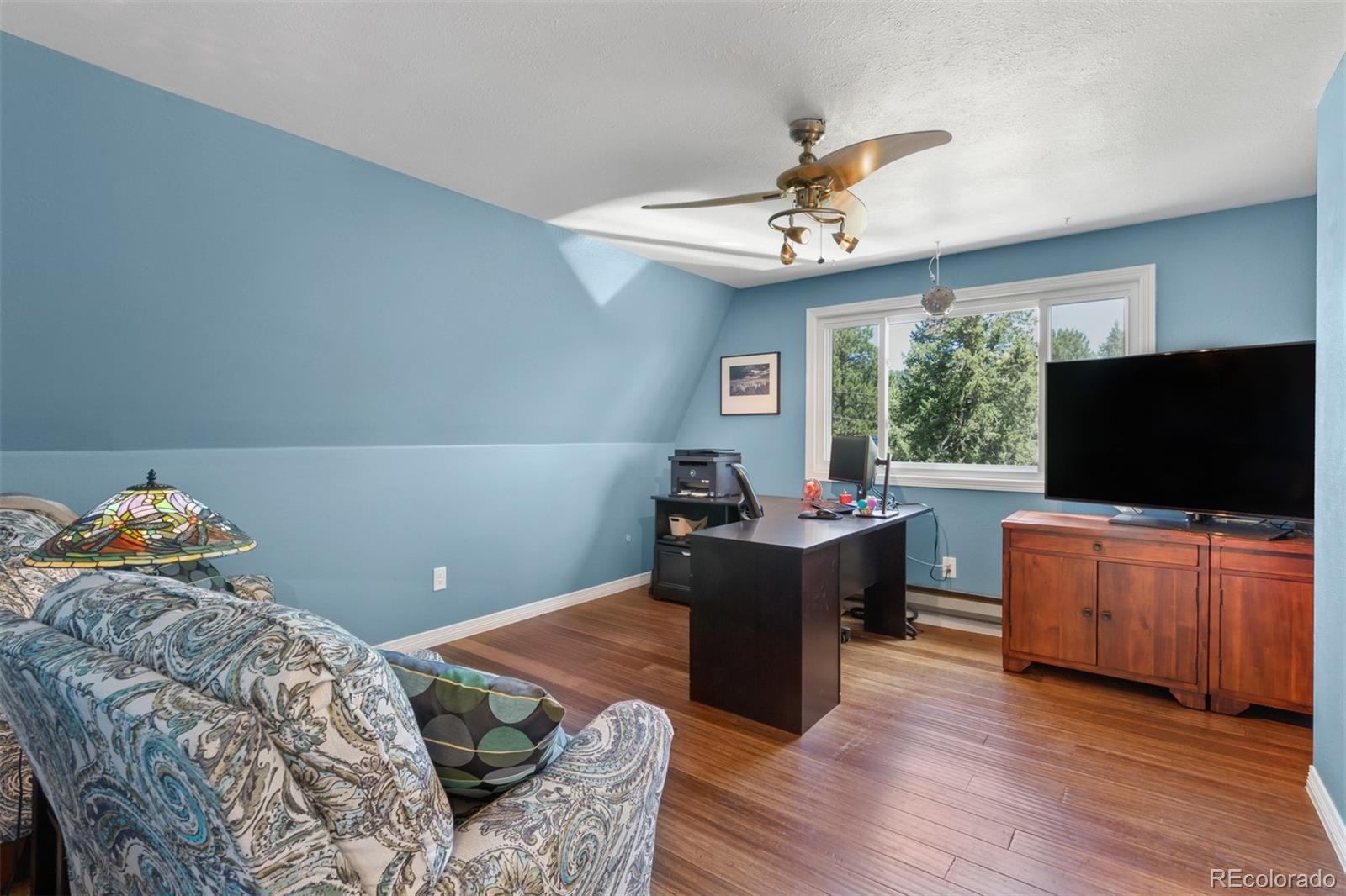 6637 High Drive Morrison, CO 80465 - Photo 18 of 28 a bedroom with furniture and a flat screen tv