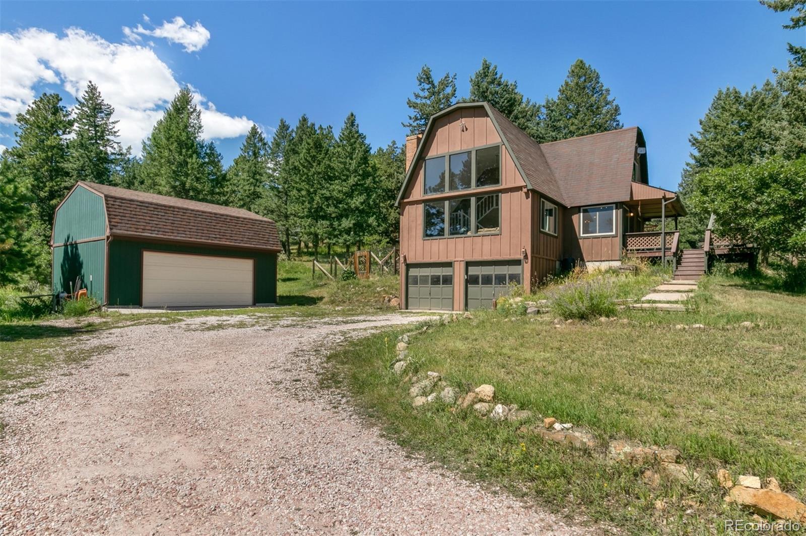 6637 High Drive Morrison, CO 80465 - Photo 2 of 28 a front view of a house with a yard and garage