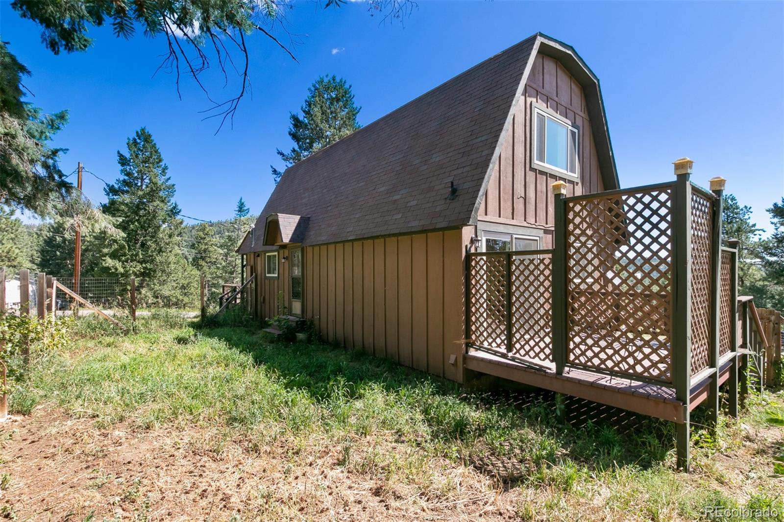 6637 High Drive Morrison, CO 80465 - Photo 27 of 28 a view of a backyard with plants and wooden fence