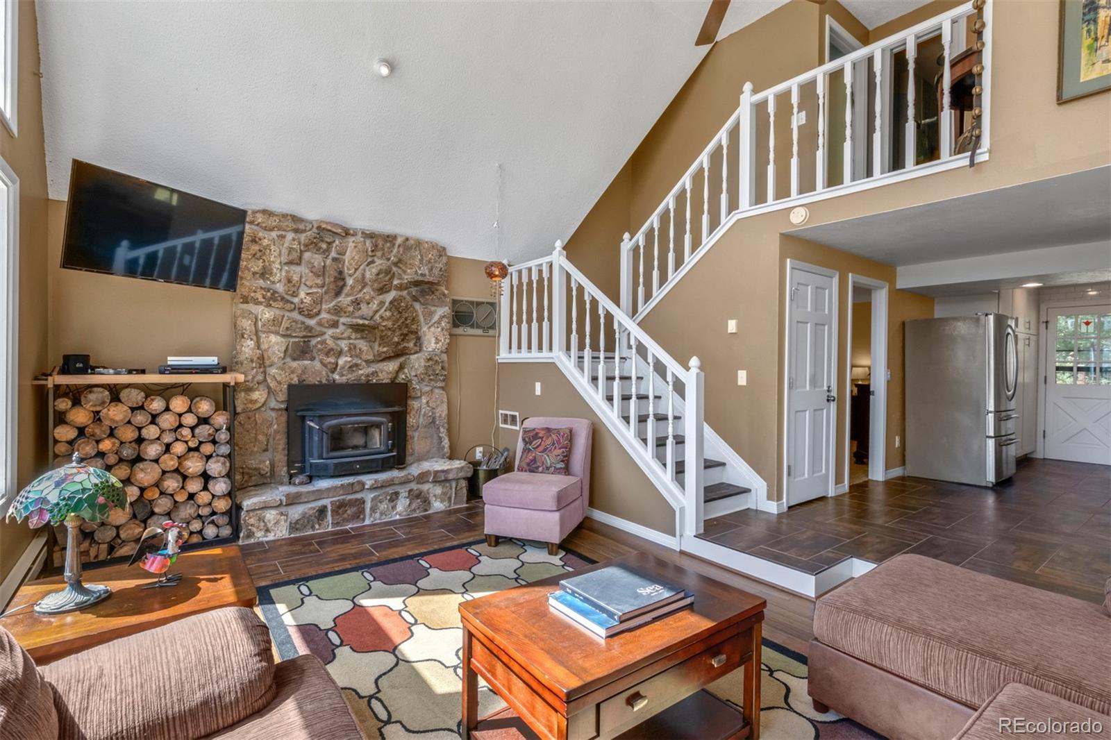 6637 High Drive Morrison, CO 80465 - Photo 6 of 28 a living room with furniture a rug and a fireplace
