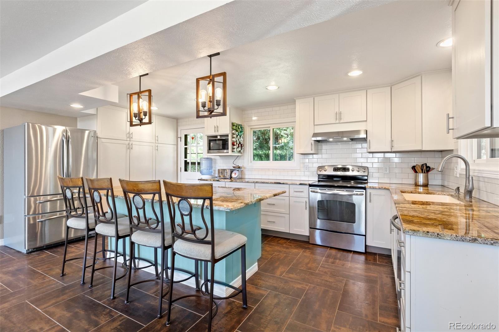 6637 High Drive Morrison, CO 80465 - Photo 10 of 28 a kitchen with a table chairs microwave and cabinets
