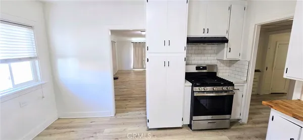 a kitchen with cabinets and appliances