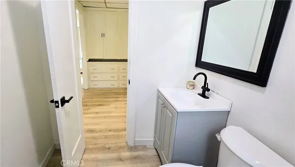 a bathroom with a sink a toilet a mirror and vanity