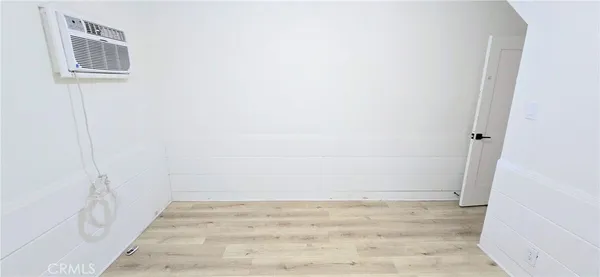 a view of a room with wooden floor and windows