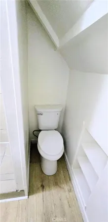 a view of an empty room and wooden floor