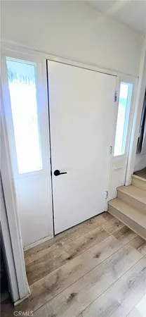 a view of a room with wooden floor and windows