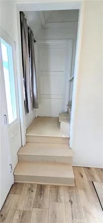 a view of staircase with white walls and a window