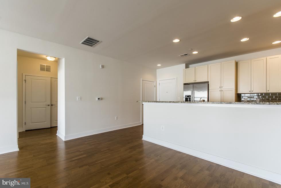 600 South 24th Street, Unit 213 Philadelphia, PA 19146 - Photo 5 of 19 a view of kitchen with cabinets stainless steel appliances and wooden floor