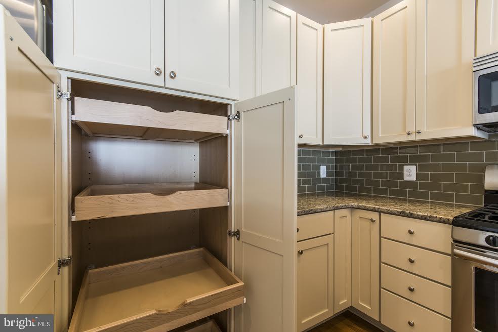 600 South 24th Street, Unit 213 Philadelphia, PA 19146 - Photo 7 of 19 a kitchen with white cabinets and a sink