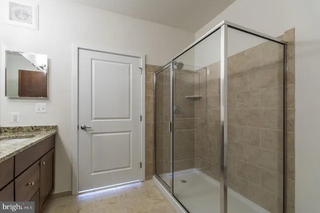 a bathroom with a shower and a sink