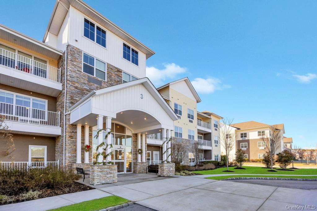 a front view of a building with a garden
