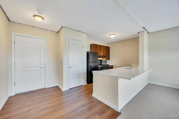 a view of kitchen with wooden floor and electronic appliances