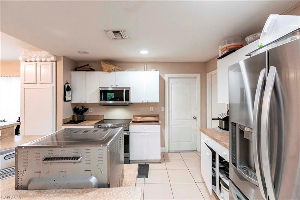 2900 8th Street Southwest Lehigh Acres, FL 33976 - Photo 12 of 32 a kitchen with stainless steel appliances granite countertop a refrigerator stove and sink