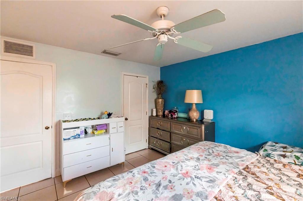 2900 8th Street Southwest Lehigh Acres, FL 33976 - Photo 16 of 32 a bedroom with a bed and cabinets