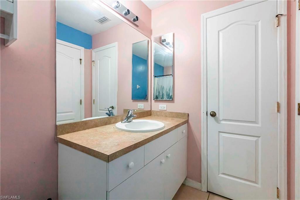 2900 8th Street Southwest Lehigh Acres, FL 33976 - Photo 18 of 32 a bathroom with a sink and a mirror
