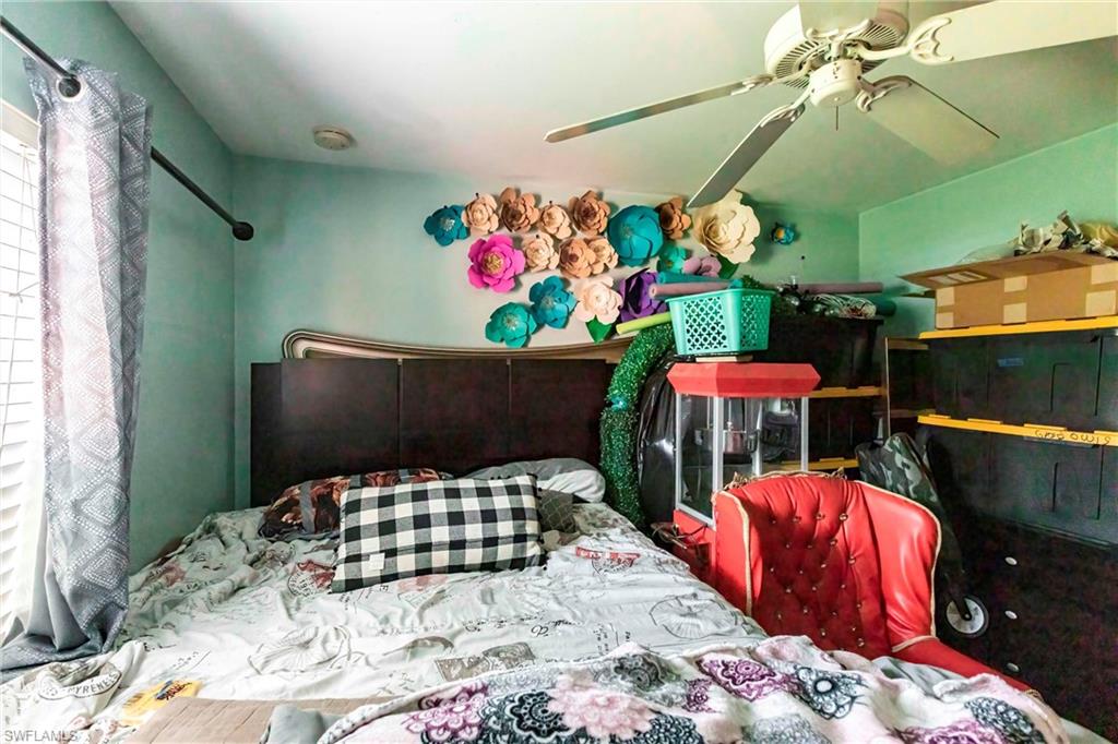 2900 8th Street Southwest Lehigh Acres, FL 33976 - Photo 19 of 32 a bedroom with a bed and a table