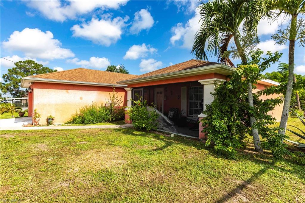 2900 8th Street Southwest Lehigh Acres, FL 33976 - Photo 2 of 32 a view of a house with a yard