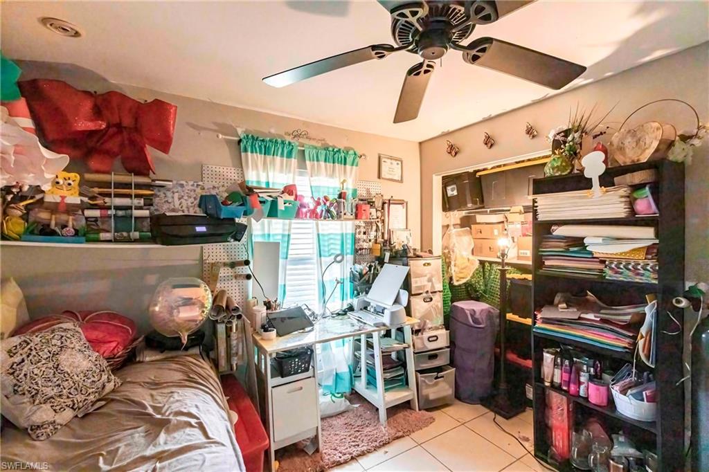 2900 8th Street Southwest Lehigh Acres, FL 33976 - Photo 23 of 32 a living room with lots of furniture and a fan