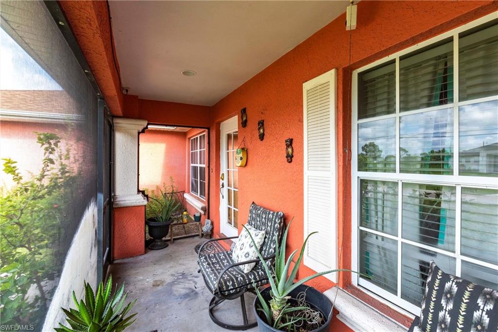 2900 8th Street Southwest Lehigh Acres, FL 33976 - Photo 27 of 32 a balcony with furniture and potted plants