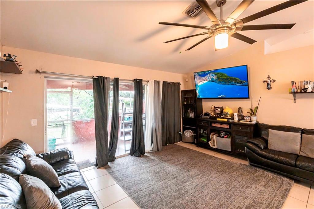 2900 8th Street Southwest Lehigh Acres, FL 33976 - Photo 6 of 32 a living room with furniture and a flat screen tv