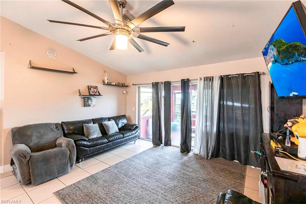 2900 8th Street Southwest Lehigh Acres, FL 33976 - Photo 8 of 32 a living room with furniture a ceiling fan and a rug