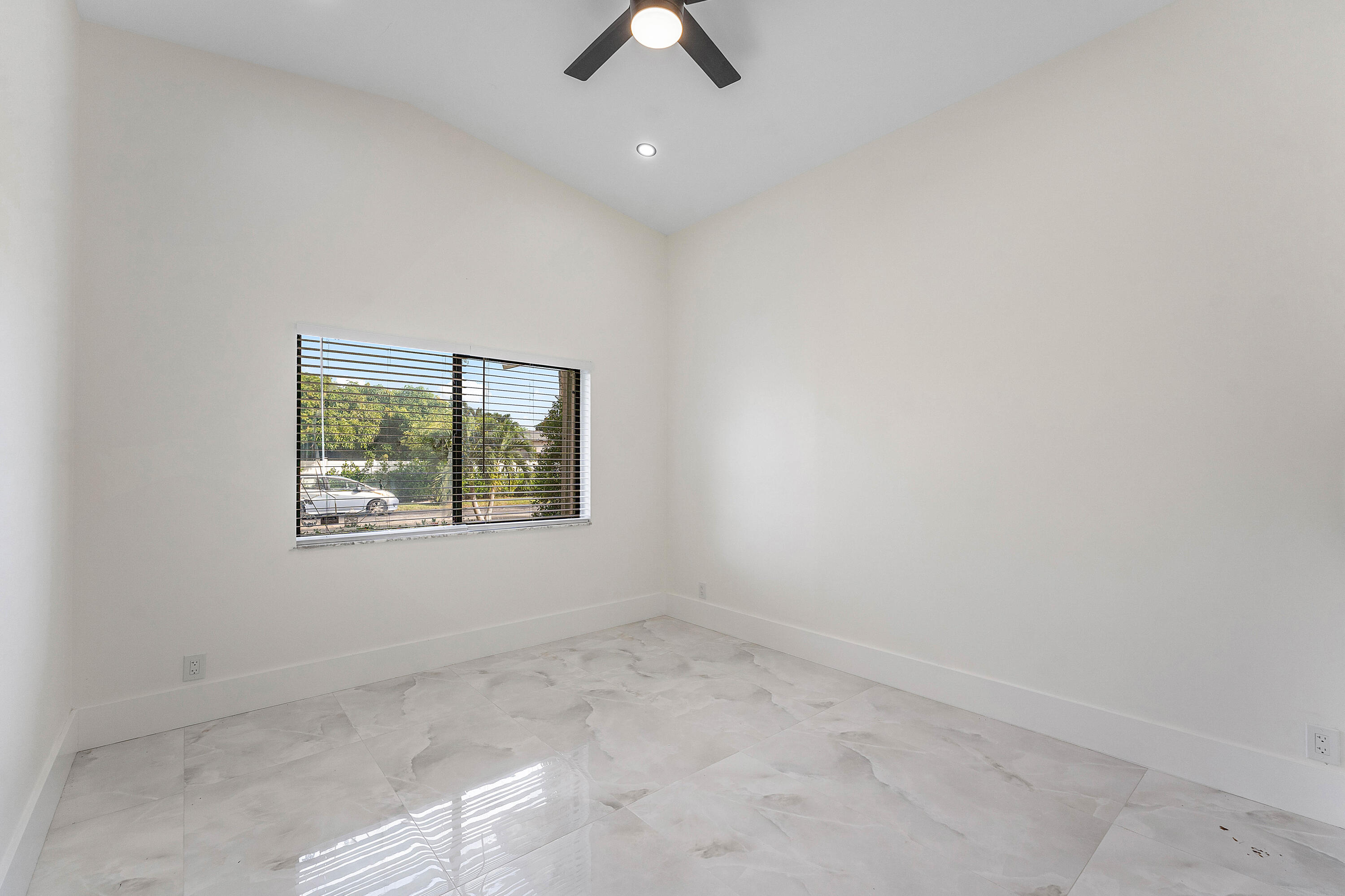 1531 Southwest 102nd Terrace Davie, FL 33324 - Photo 14 of 30 an empty room with ceiling fan and window