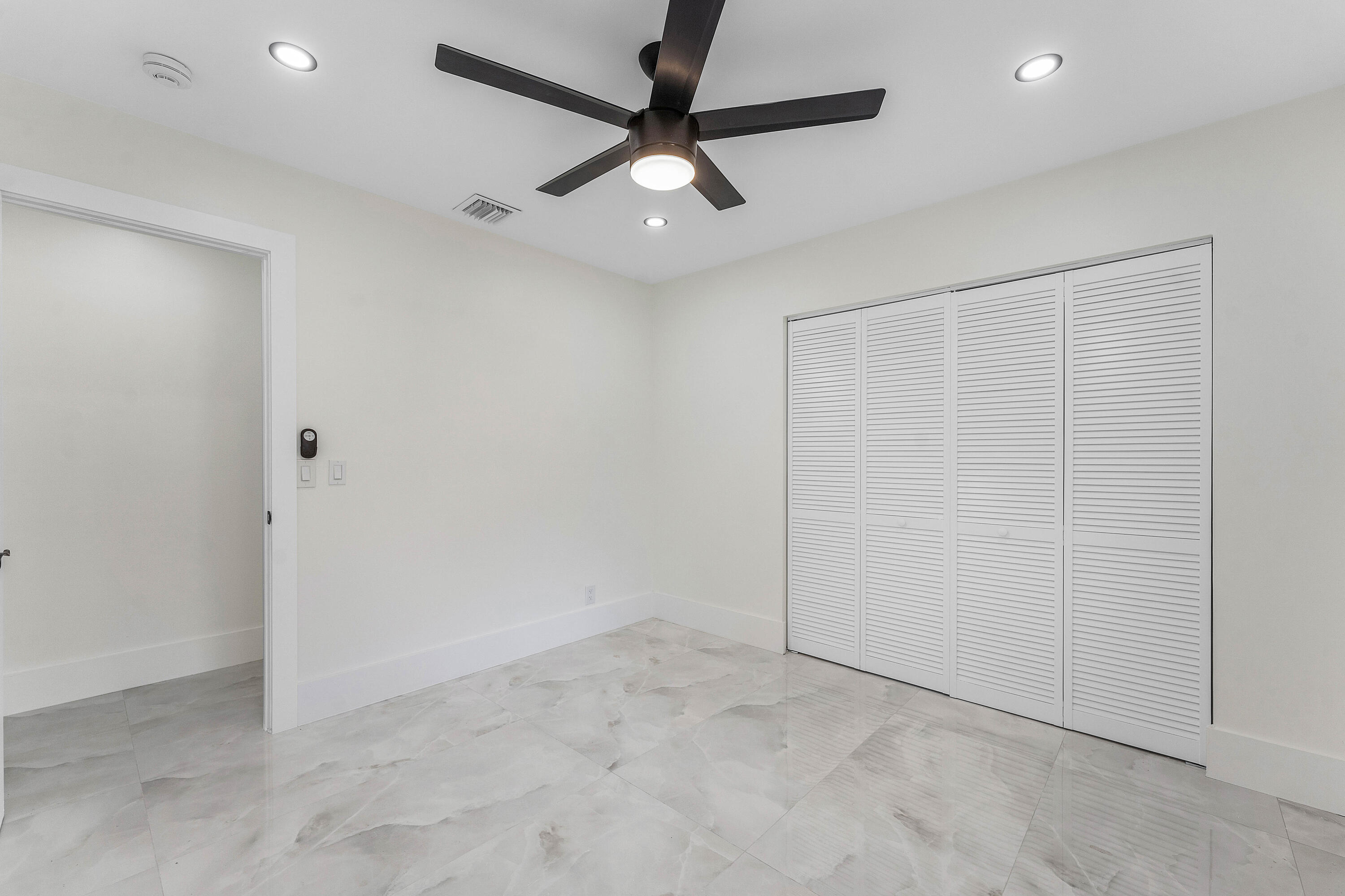 1531 Southwest 102nd Terrace Davie, FL 33324 - Photo 17 of 30 an empty room with a ceiling fan and carpet