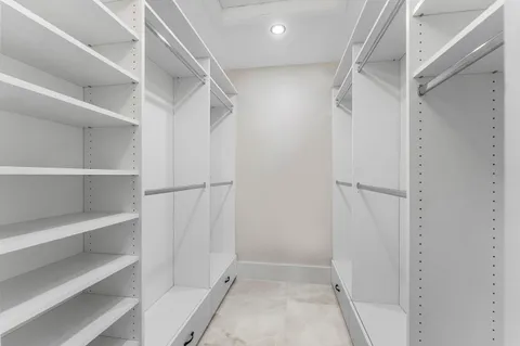 a view of walk in closet with empty racks