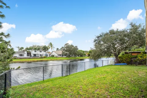 a view of a swimming pool with a yard