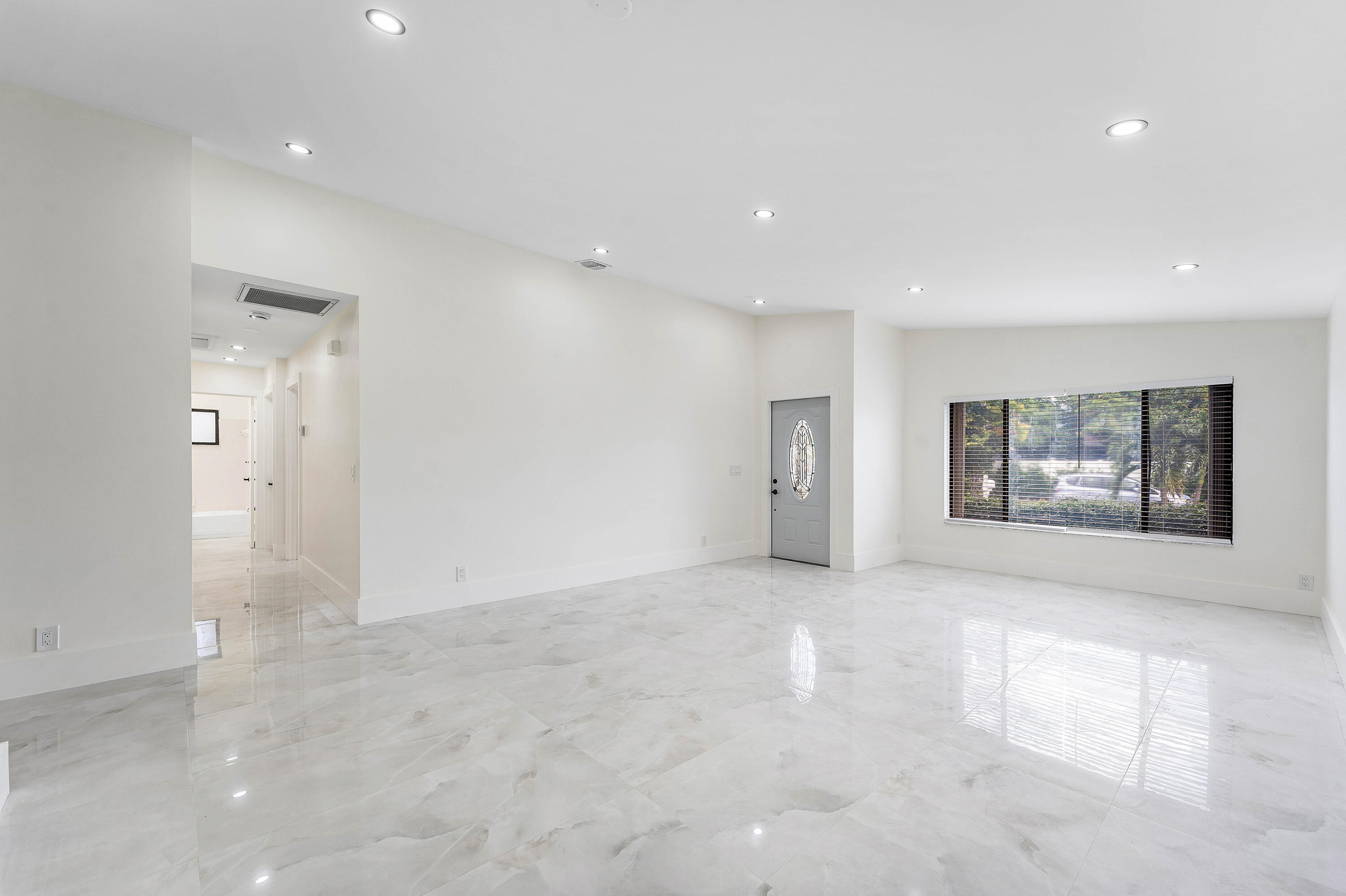 1531 Southwest 102nd Terrace Davie, FL 33324 - Photo 4 of 30 an empty room with windows and ceiling fan