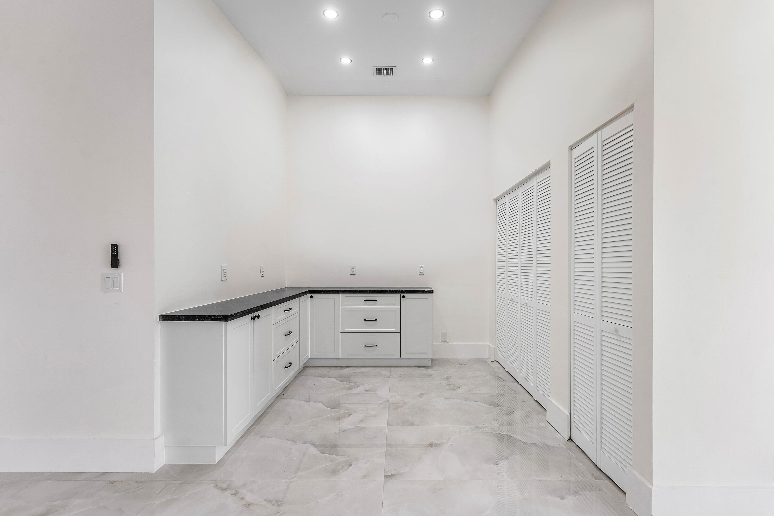 1531 Southwest 102nd Terrace Davie, FL 33324 - Photo 7 of 30 an empty room with cabinet and mirrors